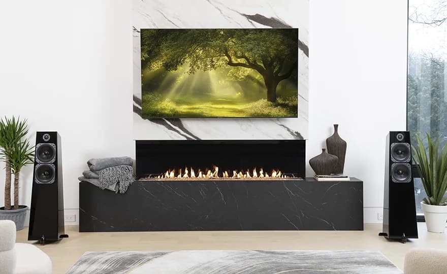 Totem Acoustic Element loudspeakers either side of a marble fireplace wall with a television